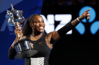 Serena Williams holds her trophy after defeating her sister Venus during the women's singles final at the Australian Open on Jan. 28, 2017, in Melbourne, Australia. (AP FILE)