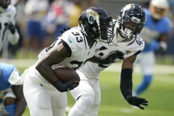 Jacksonville Jaguars linebacker Devin Lloyd runs after intercepting a pass against the Los Angeles Chargers on Sunday in Inglewood, Calif. (MARCIO JOSE SANCHEZ/Associated Press)