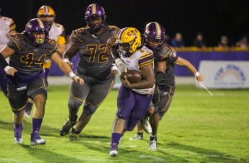 Union County’s defense swarms in to tackle Columbia running back Tony Fulton on Friday night. (BRENT KUYKENDALL/Lake City Reporter)