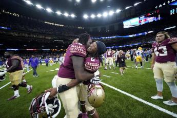 Florida State running back Treshaun Ward (8) celebrates with offensive lineman Darius Washington (76) after defeating LSU on a blocked extra point with no time remaining on Sunday in New Orleans. Florida State won 24-23. (GERALD HERBERT/Associated Press)