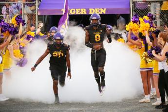 Columbia cornerback Kani Fulton (20) and cornerback/receiver Jaylen Cooper (8) lead their team out of the tunnel prior to last Friday’s game against Madison County. (BRENT KUYKENDALL/Lake City Reporter)