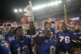 Florida safety Trey Dean III (0) and teammates celebrate after defeating Utah on Saturday in Gainesville. (PHELAN M. EBENHACK/Associated Press)