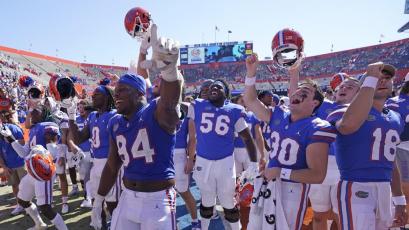 Florida players celebrate in front of fans after defeating Missouri on Saturday in Gainesville. (JOHN RAOUX/Associated Press)
