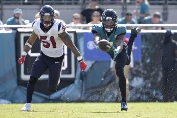 Jacksonville Jaguars wide receiver Zay Jones can't make the catch as Houston Texans linebacker Kamu Grugier-Hill defends during Sunday's game in Jacksonville. (PHELAN M. EBENHACK/Associated Press)