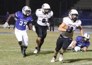 Fort White fullback Hayden Adams rushes past the Ridgeview defense on Friday night. (MORGAN MCMULLEN/Lake City Reporter)