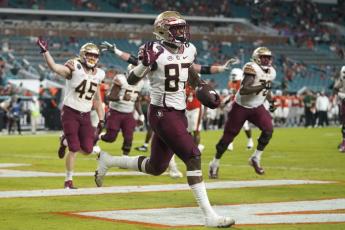 Florida State tight end Camren McDonald (87) celebrates after scoring a touchdown against Miami on Saturday in Miami Gardens. (LYNNE SLADKY/Associated Press)