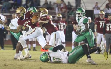 Florida High running back Micahi Danzy escapes a tackle by Suwannee linebacker Delwyn Allen during Friday’s Region 1-2S final. (PAUL BUCHANAN/Special to the Reporter)