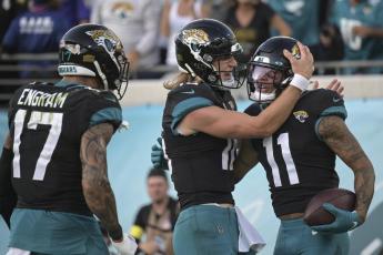 Jacksonville Jaguars wide receiver Marvin Jones Jr. (11) is congratulated by quarterback Trevor Lawrence (16) after a touchdown against the Baltimore Ravens on Sunday in Jacksonville. (PHELAN M. EBENHACK/Associated Press)