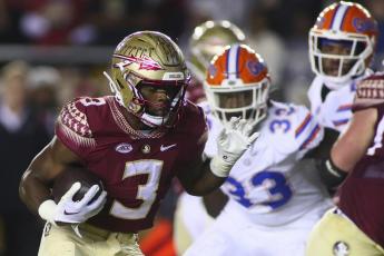 Florida State running back Trey Benson runs for a touchdown in the first quarter against Florida on Friday in Tallahassee. (PHIL SEARS/Associated Press)