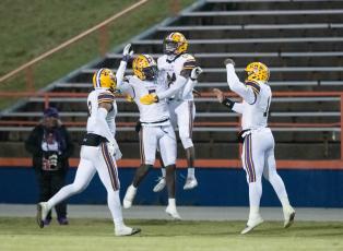 Columbia linebacker Jaden Robinson (5) celebrates with teammates after scoring on a pick-6 against Escambia during the Region 1-3S semifinals on Friday. (GREGG PACHKOWSKI/Pensacola News Journal)