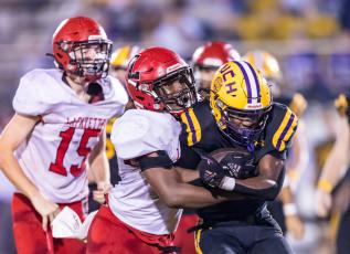 Union County running back Rayvon Durant fights for extra yardage against Lafayette during the Region 3-1R finals on Friday. (JACK HOWDESHELL/Special to the Reporter)