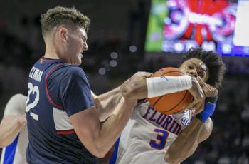 Connecticut center Donovan Clingan wrestles with Florida forward Alex Fudge for a rebound during Wednesday’s game in Gainesville. (ALAN YOUNGBLOOD/Associated Press)