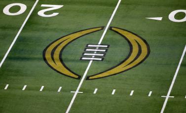 The College Football Playoff logo is shown on the field at AT&T Stadium before the Rose Bowl between Notre Dame and Alabama on Jan. 1, 2021 in Arlington, Texas. (AP FILE)