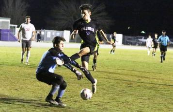 Columbia midfielder Johnathan Pineda misses on a shot in front of Santa Fe goalkeeper Rahdesh Rico Thursday night. (MORGAN MCMULLEN/Lake City Reporter)