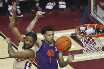 Florida State guard Darin Green, Jr. and Clemson guard Chase Hunter position themselves for a rebound on Saturday in Tallahassee. (PHIL SEARS/Associated Press)