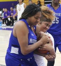 Columbia center Khalea Clark fights for possession for the basketball with Ridgeview forward Nacoya Blocton during Monday night’s game. (JORDAN KROEGER/Lake City Reporter)