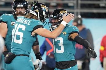 Jacksonville Jaguars wide receiver Christian Kirk (13) celebrates his touchdown reception with quarterback Trevor Lawrence (16) during Saturday's game against the Tennessee Titans in Jacksonville. (JOHN RAOUX/Associated Press)