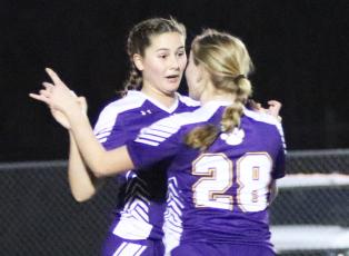 Columbia Sydney Rivas (31) celebrates with Kyndall Norris (28) after Rivas’ first of two goals against Trinity Catholic on Wednesday night. (JORDAN KROEGER/Lake City Reporter)
