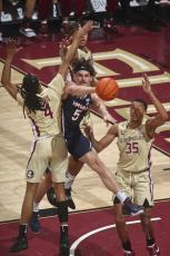 Virginia forward Ben Vander Plas passes the ball as he is triple-teamed by Florida State defenders during Saturday's game in Tallahassee. (PHIL SEARS/Associated Press)