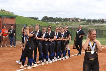 Branford's softball team stands with their runner-up medals while watching Liberty County receive its Class 1A state championship medals on Wednesday at Legends Way Ballfields in Clermont. (MORGAN MCMULLEN/Lake City Reporter)