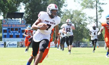 Fort White receiver Tafari Moe runs up the field after a catch against Taylor County on Saturday. (JAMIE WACHTER/Lake City Reporter)
