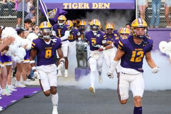 Columbia defensive back Markeyon Moore (8) and receiver Camdon Frier (12) lead their team on to the field prior to their game against Buchholz on Aug. 25. (BRENT KUYKENDALL/Lake City Reporter)