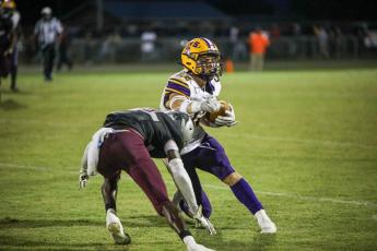 Columbia wide receiver Camdon Frier makes a move against a Madison County defender after a catch Friday night at Boot Hill. (BRENT KUYKENDALL/Lake City Reporter)