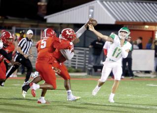 A Bradford defender deflects the ball directly out of Suwannee quarterback Koy Frier’s hand Friday night. Tornadoes linebacker Duke Lewis (5) intercepted the ball and returned it for a touchdown. (PAUL BUCHANAN/Special to the Reporter)
