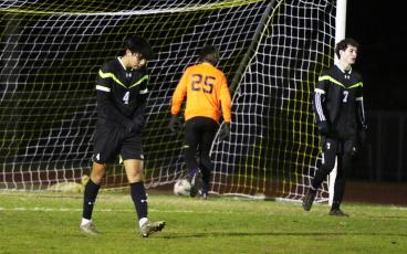 Columbia defender Diego Garcia (4) and midfielder Wesley Wingate (7) make their way back to midfield as goalie Augustus Mock gets the ball out of the net following Leon’s first goal on Wednesday night. (MORGAN MCMULLEN/Lake City Reporter)