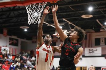 Fort White guard Tafari Moe gets off a shot while being defended by Hawthorne guard CJ Ingram during Thursday's District 6-1A semifinal. (BRENT KUYKENDALL/Lake City Reporter)