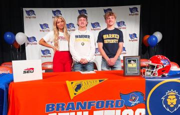 Branford outside hitter Jadyn Mosley (from left, Southeastern), defensive back Colby Carver (Warner) and receiver Austin Malaguti (Warner) signed their letters of intent on Wednesday. (COURTESY)