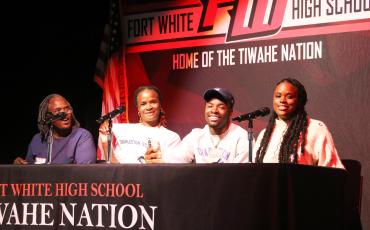 Fort White running back Dakota Fisher (second from right) signed his letter of intent to play football at Charleston Southern University on Wednesday flanked by his (from left) grandmother Shirley Adams, mother Tonya Fisher and sister Jamisha Walls. (MORGAN MCMULLEN/Lake City Reporter)