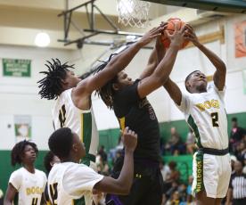 Columbia forward Jalen Gaskins (middle) fights for a rebound with Suwannee guards Jamarcus Cherry (11) and Jhy Smith (2) during Tuesday’s game. (PAUL BUCHANAN/Special to the Reporter)