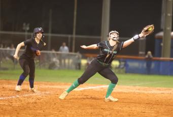 Suwannee third baseman Haley Law makes a catch as Branford outfielder Ashlee Combee looks on at third base on March 6. (PAUL BUCHANAN/Special to the Reporter)