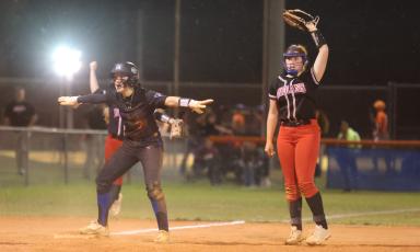 Branford's Cloey Criggall signals safe at third base alongside Fort White's Hannah LeBleu on March 1. (PAUL BUCHANAN/Special to the Reporter)