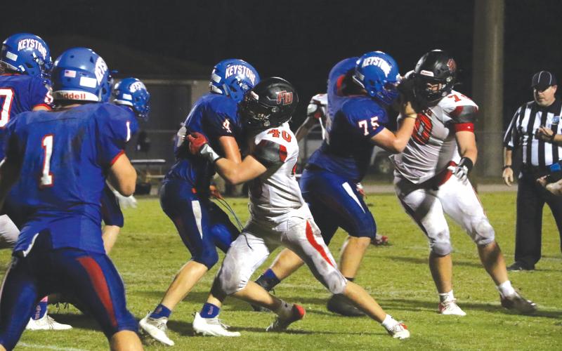 Fort White linebacker Coby Lee tackles Keystone Heights running back Dalton Hollingsworth on Friday night. (MORGAN MCMULLEN/Lake City Reporter)