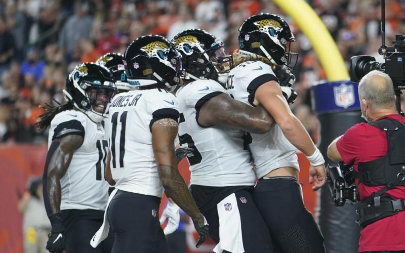 Jacksonville Jaguars quarterback Trevor Lawrence, front, celebrates with teammates after rushing for a touchdown against the Cincinnati Bengals on Sept. 30 in Cincinnati. (MICHAEL CONROY/Associated Press)
