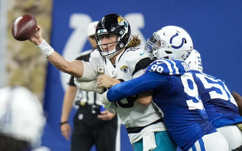 Jacksonville Jaguars quarterback Trevor Lawrence is hit by Indianapolis Colts defensive tackle DeForest Buckner during Sunday’s game in Indianapolis. (AJ MAST/Associated Press)
