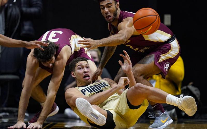 Purdue forward Mason Gillis (0) makes a pass from the floor in front of Florida State guard Anthony Polite (2) during Tuesday’s game in West Lafayette, Ind. (MICHAEL CONROY/Associated Press)