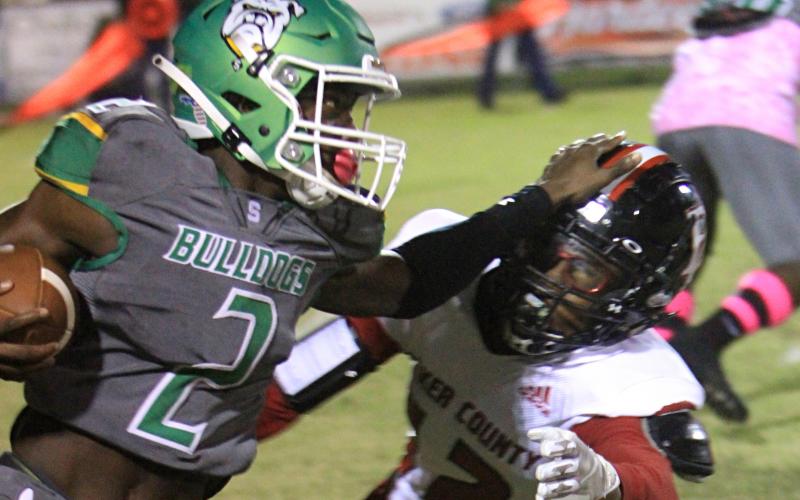 Suwannee receiver Jay Smith stiff arms a Baker County defender on Oct. 29. (PAUL BUCHANAN/Special to the Reporter)