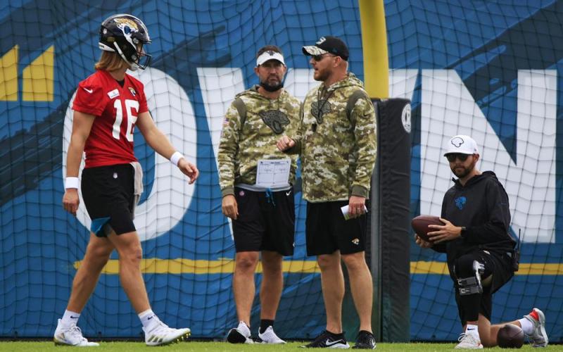 Jacksonville Jaguars interim head coach Darrell Bevell, an offensive coordinator under former coach Urban Meyer, leads practice while talking with quarterback Trevor Lawrence on Dec. 16 at TIAA Bank Field's practice field in Jacksonville. (COREY PERRINE/The Florida Times-Union via AP)