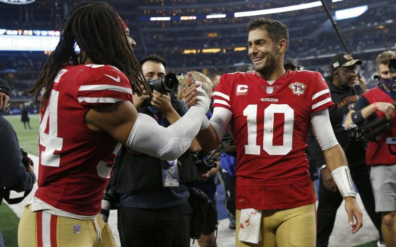 San Francisco 49ers middle linebacker Fred Warner, left, celebrates with quarterback Jimmy Garoppolo (10) after the 49ers defeated the Dallas Cowboys in a wild-card playoff game on Sunday in Arlington, Texas. (ROGER STEINMAN/Associated Press)