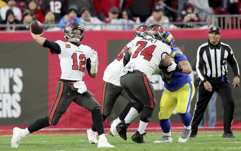 Tampa Bay Buccaneers quarterback Tom Brady (12) passes the ball as Tampa Bay Buccaneers guard Ali Marpet (74) blocks during an NFL divisional playoff game between the Los Angeles Rams and Tampa Bay Buccaneers on Jan. 23 in Tampa. (AP FILE)