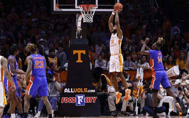 Tennessee guard Josiah-Jordan James (30) goes for a dunk past Florida guard Kowacie Reeves (14) during Wednesday's game in Knoxville, Tenn. Tennessee won 78-71. (WADE PAYNE/Associated Press)
