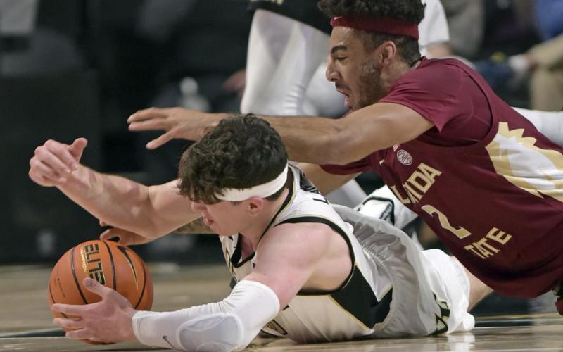 Wake Forest's Jake LaRavia, bottom, and Florida State's Anthony Polite battle for a loose ball during Tuesday's game at Joel Coliseum in Winston-Salem, N.C. (WALT UNKS/The Winston-Salem Journal via AP)