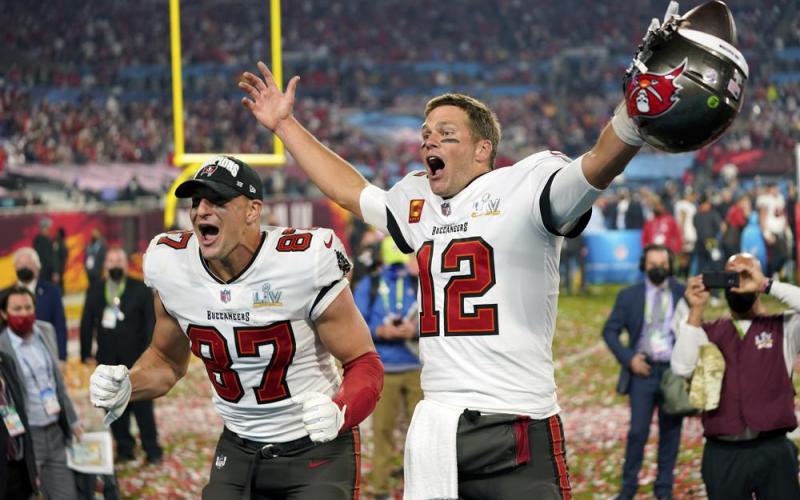 Tampa Bay Buccaneers tight end Rob Gronkowski, left, and quarterback Tom Brady (12) celebrate after winning Super Bowl 55 against the Kansas City Chiefs on Feb. 7, 2021 in Tampa. (AP FILE)