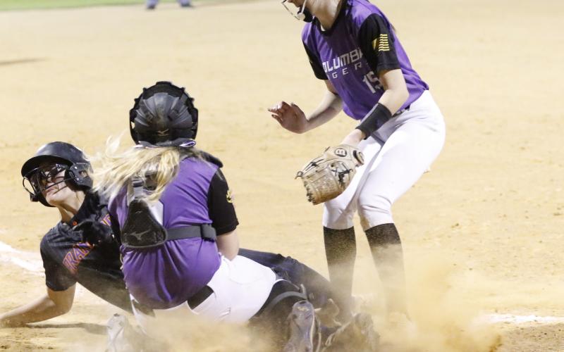 Branford outfielder Ellie Frierson slides into home plate safely to score a run before Columbia catcher Haley Cook can apply a tag on Tuesday night. (JORDAN KROEGER/Lake City Reporter)