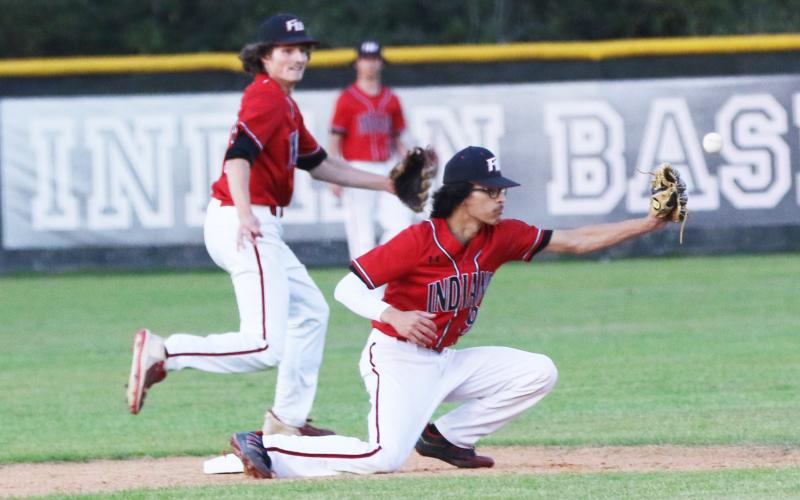 Fort White second baseman Daniel Gonzalez can’t pull in a throw from home plate as Union County attempts to steal second base during Thursday night’s game. (JORDAN KROEGER/Lake City Reporter)