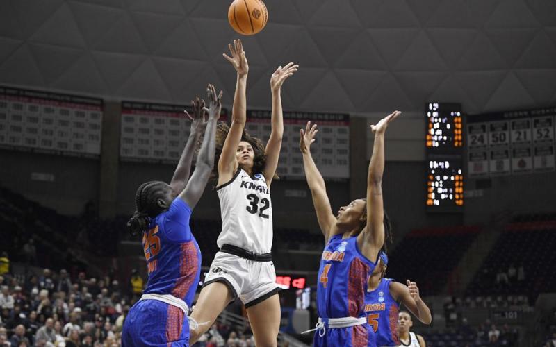 Central Florida's Brittney Smith, center, shoots between Florida's Faith Dut, left, and Florida's Zippy Broughton, right, during their first-round game in the NCAA tournament on Saturday Storrs, Conn. (JESSICA HILL/Associated Press)