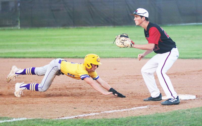 Columbia’s Matt Dumas slides back to first base to beat a pickoff throw during Wednesday’s game against Baker County. (JORDAN KROEGER/Lake City Reporter)